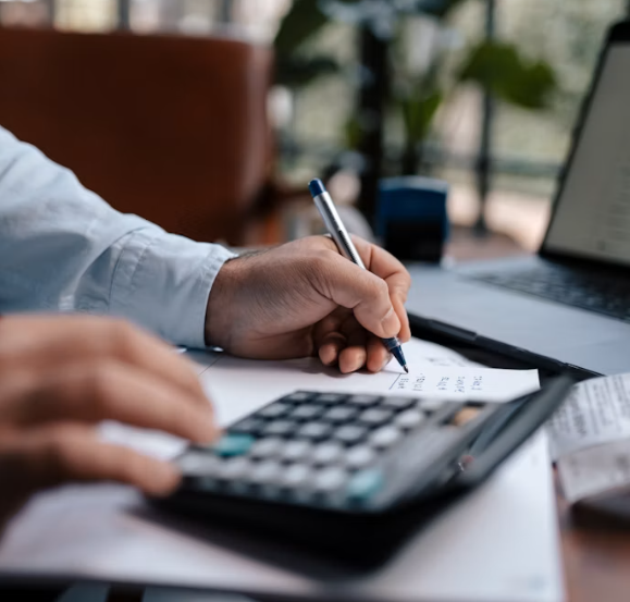 Accounting workspace with calculator, notebook and financial planning materials